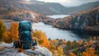 beautiful traveler backpack on a stone with a lake and mountains in the background in autumn in high resolution and high quality