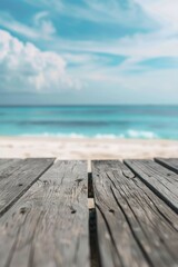 Wall Mural - A wooden table on a beach with the ocean in the background. Suitable for travel and vacation concepts