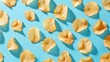 A group of potato chips on a blue surface. Perfect for food and snack concepts