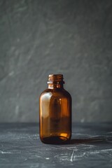 Poster - A brown glass bottle sitting on a table. Suitable for various concepts