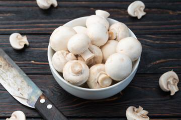 Wall Mural - Many raw mushroom champignon  on wooden background