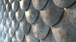 A wall with a series of grey, rounded tiles that resemble a roof