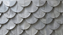 A Wall With A Pattern Of Metal Tiles That Resemble A Dragon's Scales