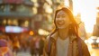© valiantsin - Joyful Asian woman walking in the city street. Happy, cheerful portrait of young female traveler