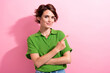 Photo of positive pretty young woman dressed green shirt showing finger empty space isolated pink color background
