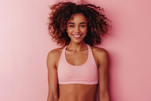 A Woman With Curly Hair Is Smiling And Wearing A Pink Tank Top
