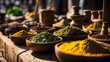 Spices and herbs in wooden bowls on a market in India.