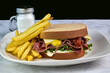 pastrami sandwich served with french fries