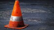 an orange traffic cone on the street