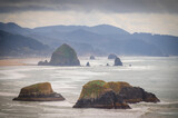 Fototapeta Most - View of Haystack Rock from Ecola State Park. Known for some of the best views on the Oregon Coast and Haystack Rock, Ecola State Park is an ideal spot to watch enormous storm waves roll in.