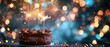 A chocolate cake with sparklers on top and blurred shiny bokeh background. happy new year