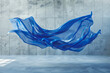 Abstract blue cloth flying in the air in concrete studio