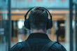 Rear view of a security guard listening to his headset 