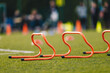 Sports Training Hurdles. Kids in Soccer Practice in Blurred Background. Football Practice Equipment
