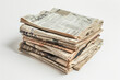 tactile quality and vintage aesthetic of old newspapers arranged in a pile, against a clean white background, inviting viewers to immerse themselves in the richness of print histor