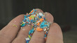 Close-up shot of microplastic particles in a human hand. Concept of plastic pollution with nanoplastics. Selective focus on a micro plastic particles that cannot be recycled