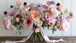   A bouquet of pink and white flowers on a weathered wooden table, adorned with a ribbon at its base