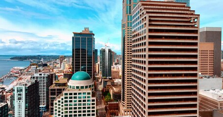 Wall Mural - Drone flying between the high-rise buildings in the downtown of Seattle, WA, United States. Beautiful cityscape of metropolis at day.