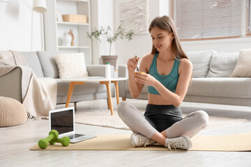 Sticker - Sporty young woman with tasty yogurt at home