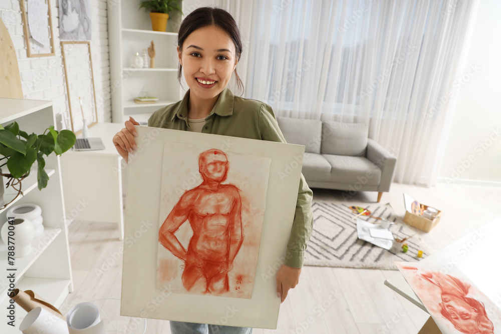 Female Asian artist with painting in workshop