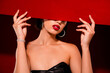 Photo of gorgeous korean young lady hide face banner dressed black leather garment isolated on red color background