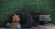 School scene with young Caucasian male sleeping on a desk