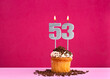 Birthday celebration with candle number 53 - Chocolate cupcake on pink background