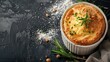 Freshly baked savory pie garnished with herbs on dark surface