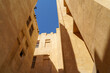 Doha, Qatar - Jan 14 2024, Bottom-up view of the narrow courtyard of the well, the blue sky is visible on top, in Souq Waqif area, at daytime, Doha, Qatar