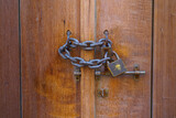 Fototapeta Do pokoju - Doha, Qatar Close up view of a vintage lock with chain on a wooden door
