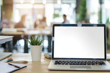 A closeup of an open laptop with a blank screen on a wooden desk, surrounded by papers and a coffee cup in the office background.