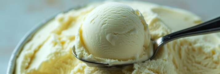 Wall Mural - Close-up of a vanilla ice cream scoop in a spoon, wide panoramic format.