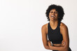 Biracial woman laughing in studio, wearing black sportswear, copy space