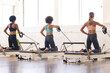 © Wavebreak Media - Three diverse women are exercising on pilates reformer machines in a studio