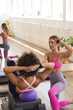 © Wavebreak Media - Two women are practicing pilates in studio, one biracial, one Caucasian, copy space