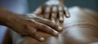 A closeup of a masseuses hands gently manipulating a clients back muscles representing the physical and handson nature of holistic healthcare. .