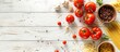 © Lasvu - Tomatoes and pasta ingredients displayed on a white wooden table, viewed from above with space for text.