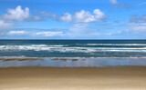 Fototapeta Miasta - Beach seascape with blue sky and clouds