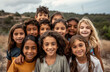 © Kien - A group of multiethnic children smile and play together outdoors on a sunny day
