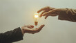 The hand of a businessman passing a light bulb to his other hand on a white background, depicting the idea and creativity concept, in a flat lay collage style. A pair of hands are exchanging.