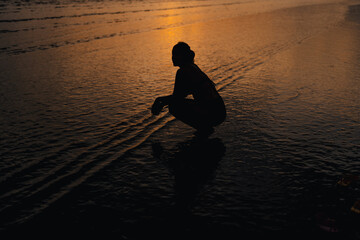 Wall Mural - Silhouette of woman on calm beach and sky Evening at Ao Nang, Krabi