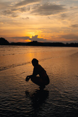 Wall Mural - Silhouette of woman on calm beach and sky Evening at Ao Nang, Krabi