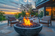  A modern fire bowl with a textured surface, placed on an outdoor patio of a luxury house overlooking a green landscape at sunset. Created with Ai