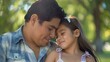 In the park a Hispanic father lovingly embraces his young daughter as they share a heartwarming moment outdoors gazing into each other s eyes with bright smiles