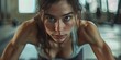 Stunning dark-haired woman preparing and performing push-ups at the fitness center.