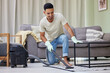 Cleaning, vacuum and man in home with appliance for chores, housework or responsibility. Bacteria, furniture and smile with happy person on floor of apartment for control or hygiene in morning
