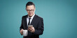 Businessman checking smartphone with coffee