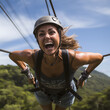 A smiling and happy woman on a zip line in Monteverde, Costa Rica.
