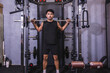 © Mdv Edwards - Dedicated and focused young male athlete doing back squats on a smith machine in a well-equipped gym, showing strength and concentration.