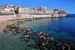 The Eastern rocky coast of Ortigia Island, Syracuse, Sicily, Italy, with clear and colorful water